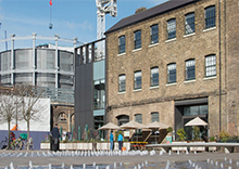 The Kings Cross redevelopment site, with original buildings in the foreground which have been converted into a cafe.